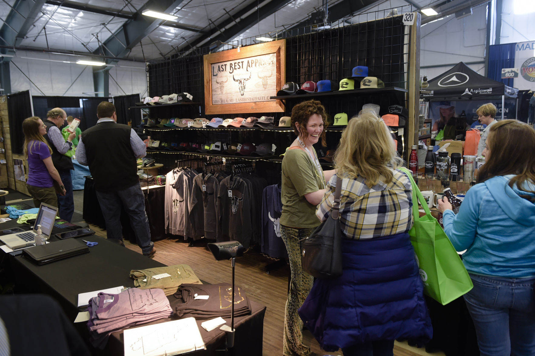 Joyce Gibbs, center, speaks with prospective buyers recently at the Montana Made Trade Show in Helena.